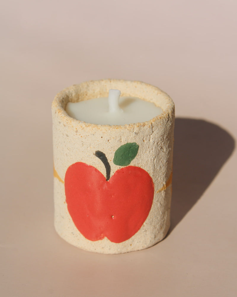 Pomelle mini scented candle in handmade ceramic holder with red apple motif, cute decorative candle for cozy home decor.
