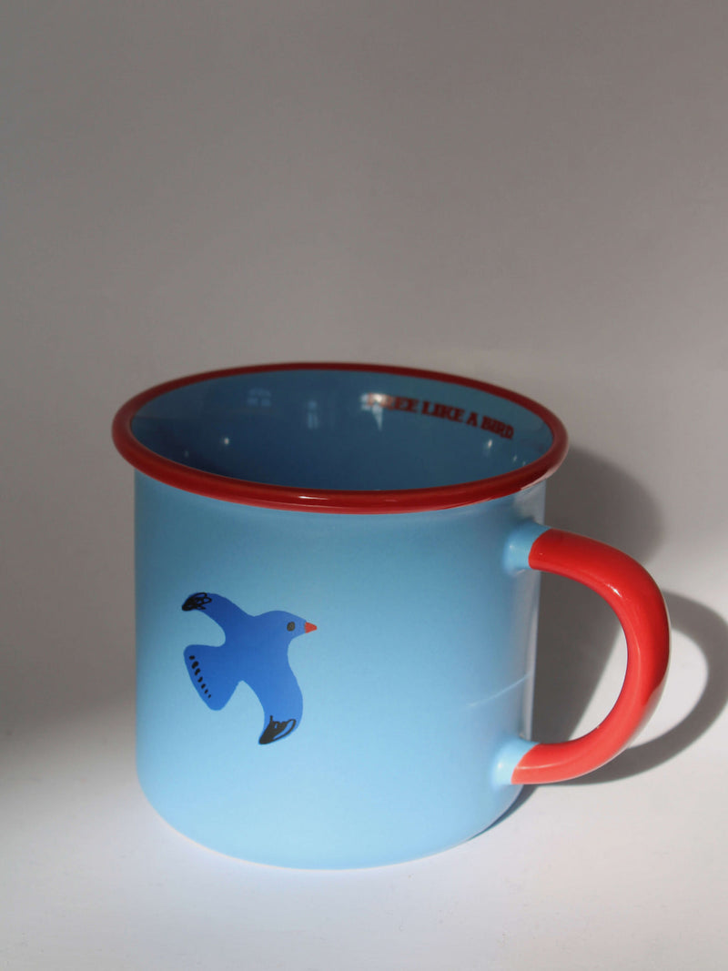 Birdie ceramic mug in soft blue with red rim and handle, minimalist handmade coffee cup in dramatic light