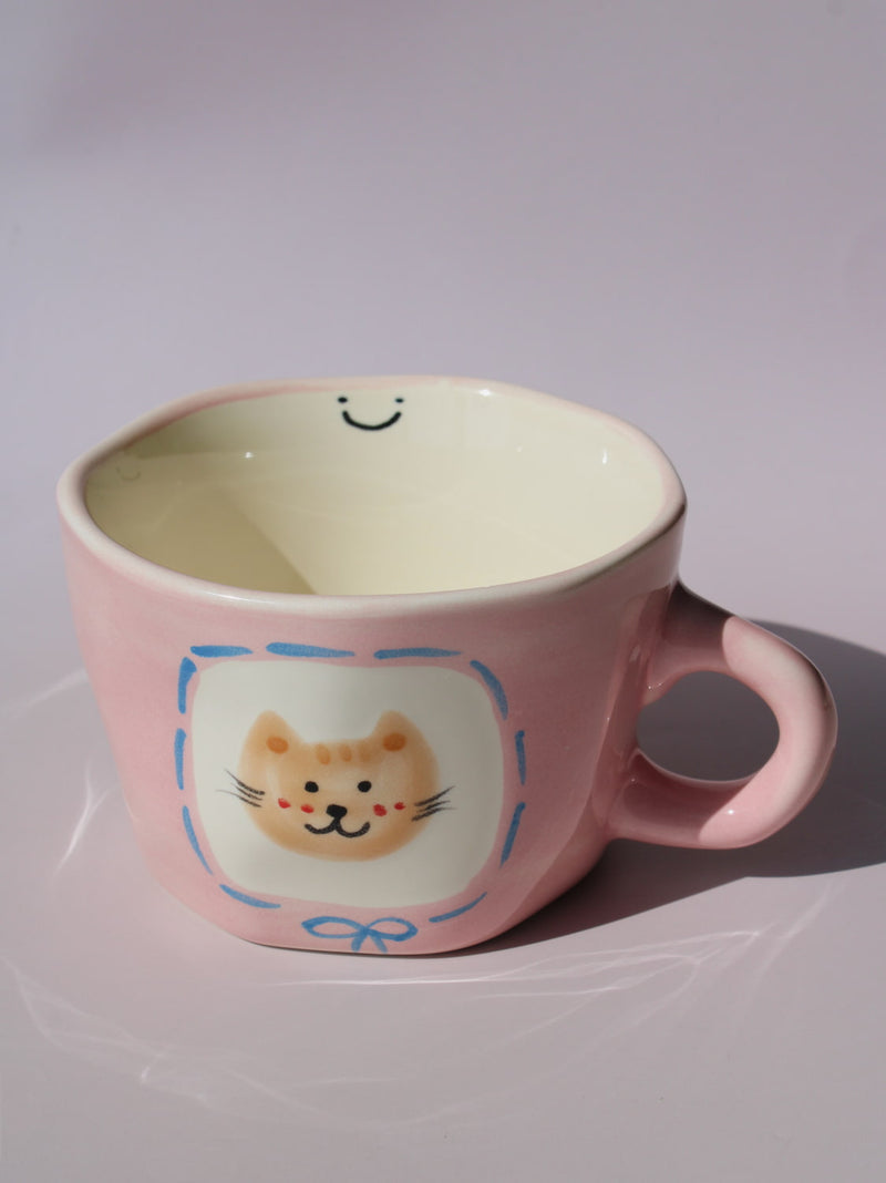 Mimi Ceramic Mug in pink with hand-painted cat face and smiley face inside, handmade ceramic coffee mug