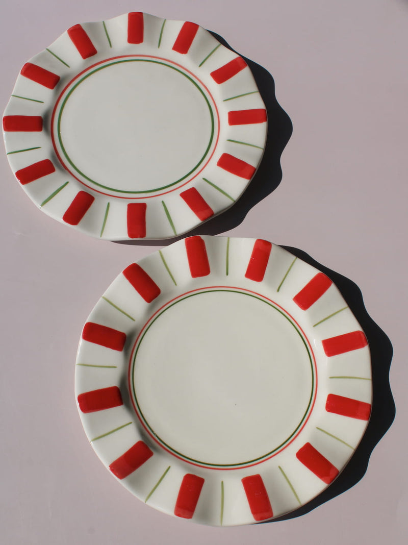 Riviera Ceramic Plate with red and green sunray pattern on scalloped rim, handmade ceramic dessert plate top view