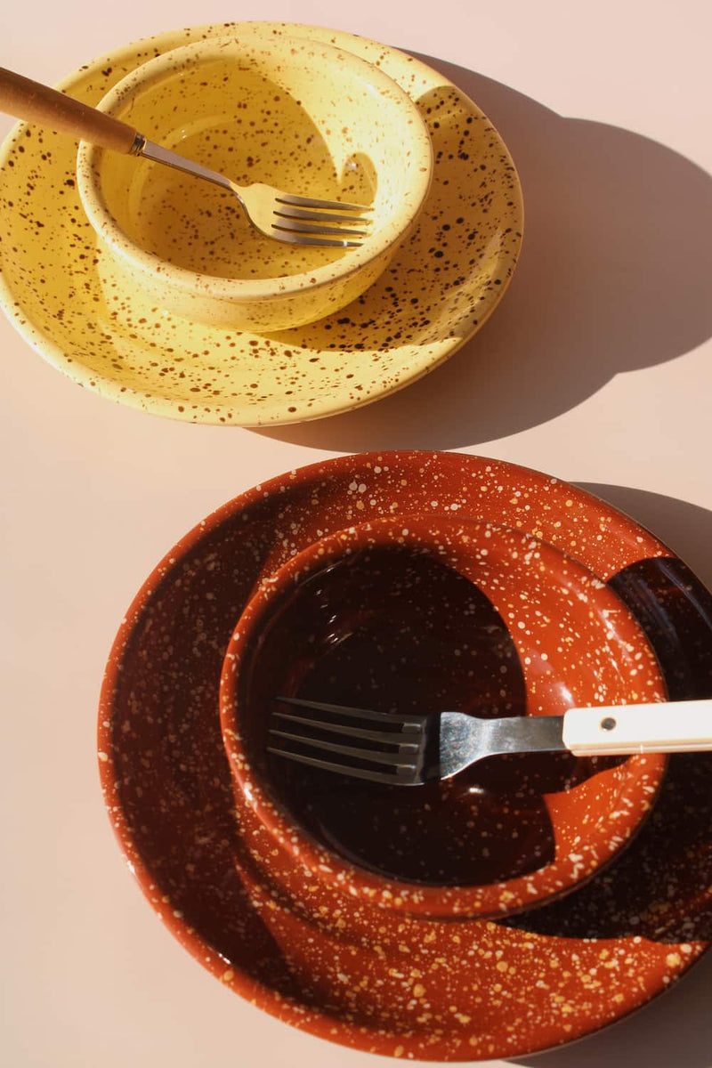 Ocre and Roca ceramic bowl sets styled together, speckled handmade stoneware bowls with matching plates.