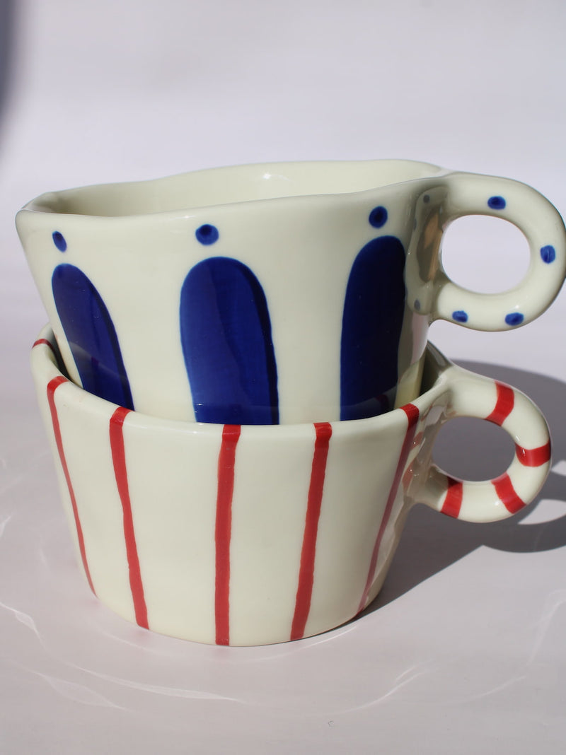 Enzo and Arlo Ceramic Mug with bold blue arch stripes and polka dot handle on cream base, handmade pottery coffee mug