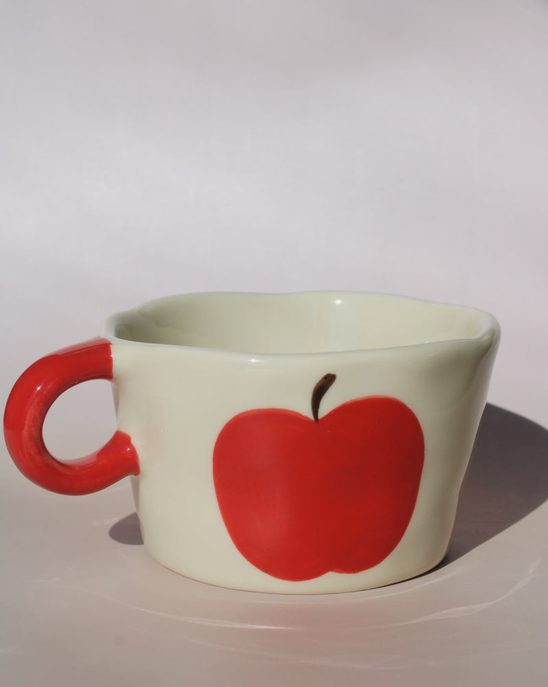 Apple motif ceramic mug with red apple illustration and red handle, handmade aesthetic coffee cup.