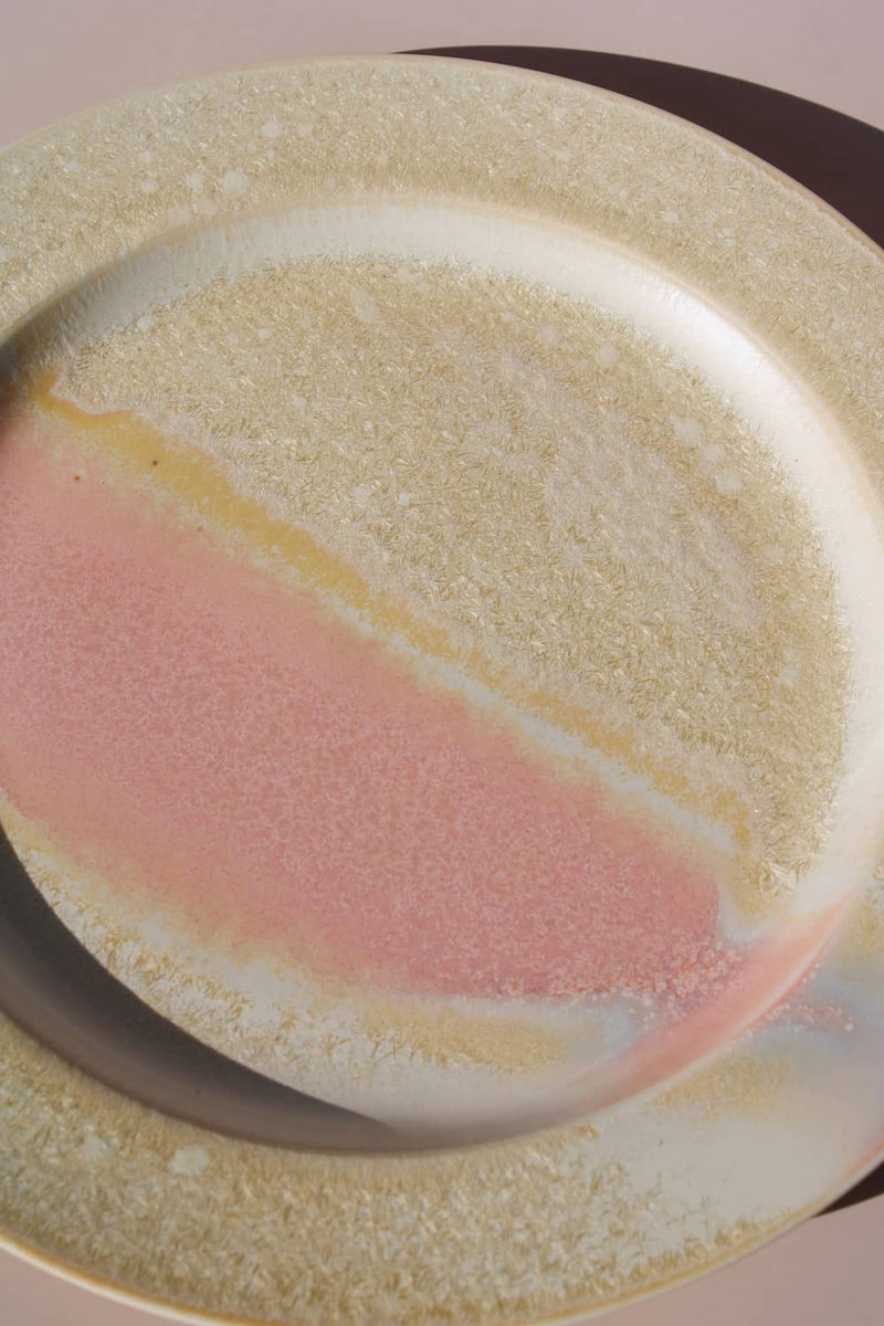 Aurora ceramic plate with soft pink glaze and textured beige rim, modern handmade dinnerware.