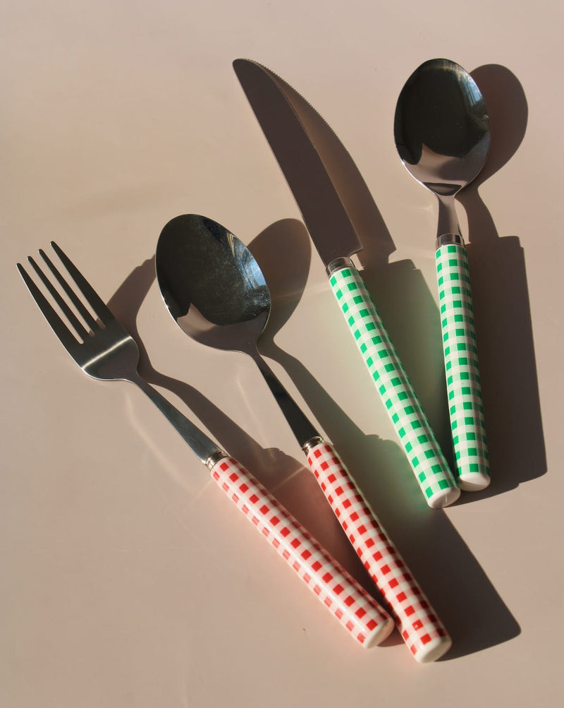 Roux and Nico stainless steel cutlery set with red and green gingham handles, modern flatware including fork, knife, and spoons.