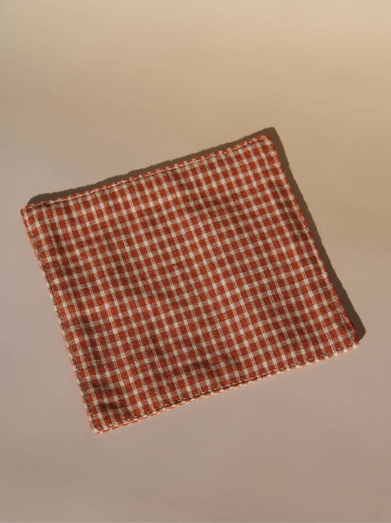 Red and white checkered fabric on a beige background