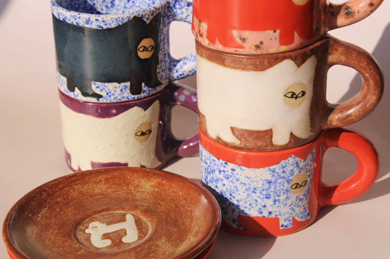 stack of handmade ceramic cat mugs by Marta Shurpakova colorful artisan espresso coffee cups