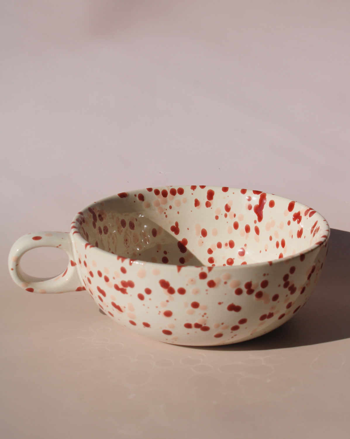 Bera ceramic bowl with pink and red speckled glaze, handmade soup bowl with handle for cozy table settings.