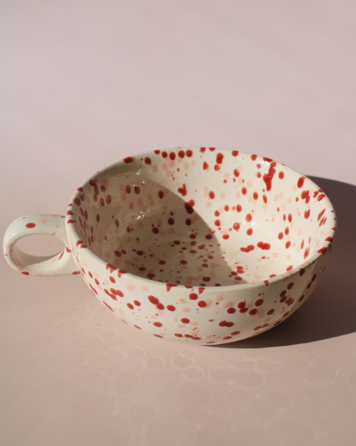 Bera ceramic bowl with pink and red speckled glaze, handmade soup bowl with handle for cozy table settings.