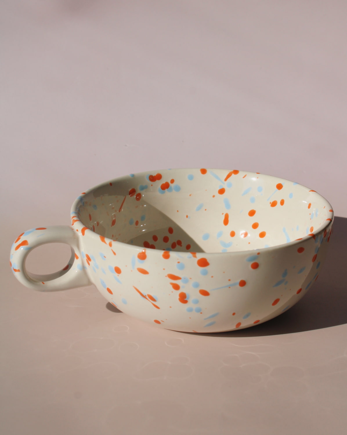 Naro ceramic bowl with blue and orange speckled glaze, handmade soup bowl with handle for everyday dining.