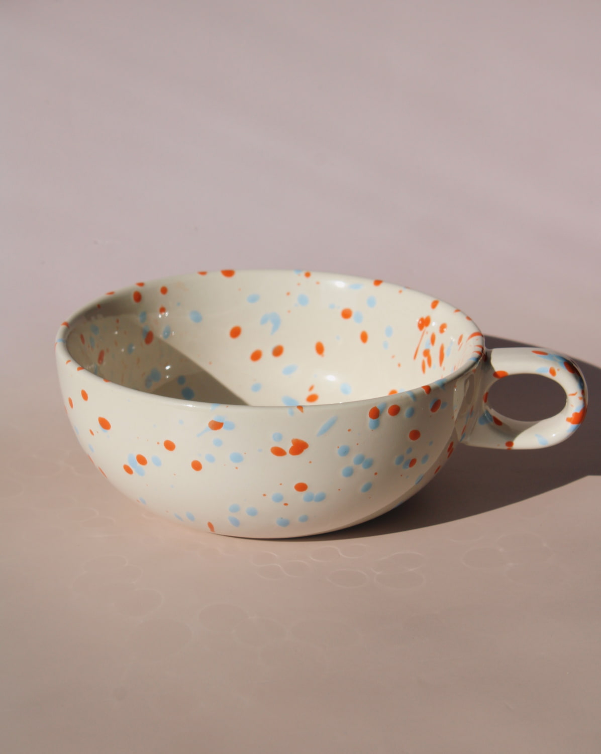 Naro ceramic bowl with blue and orange speckled glaze, handmade soup bowl with handle for everyday dining.