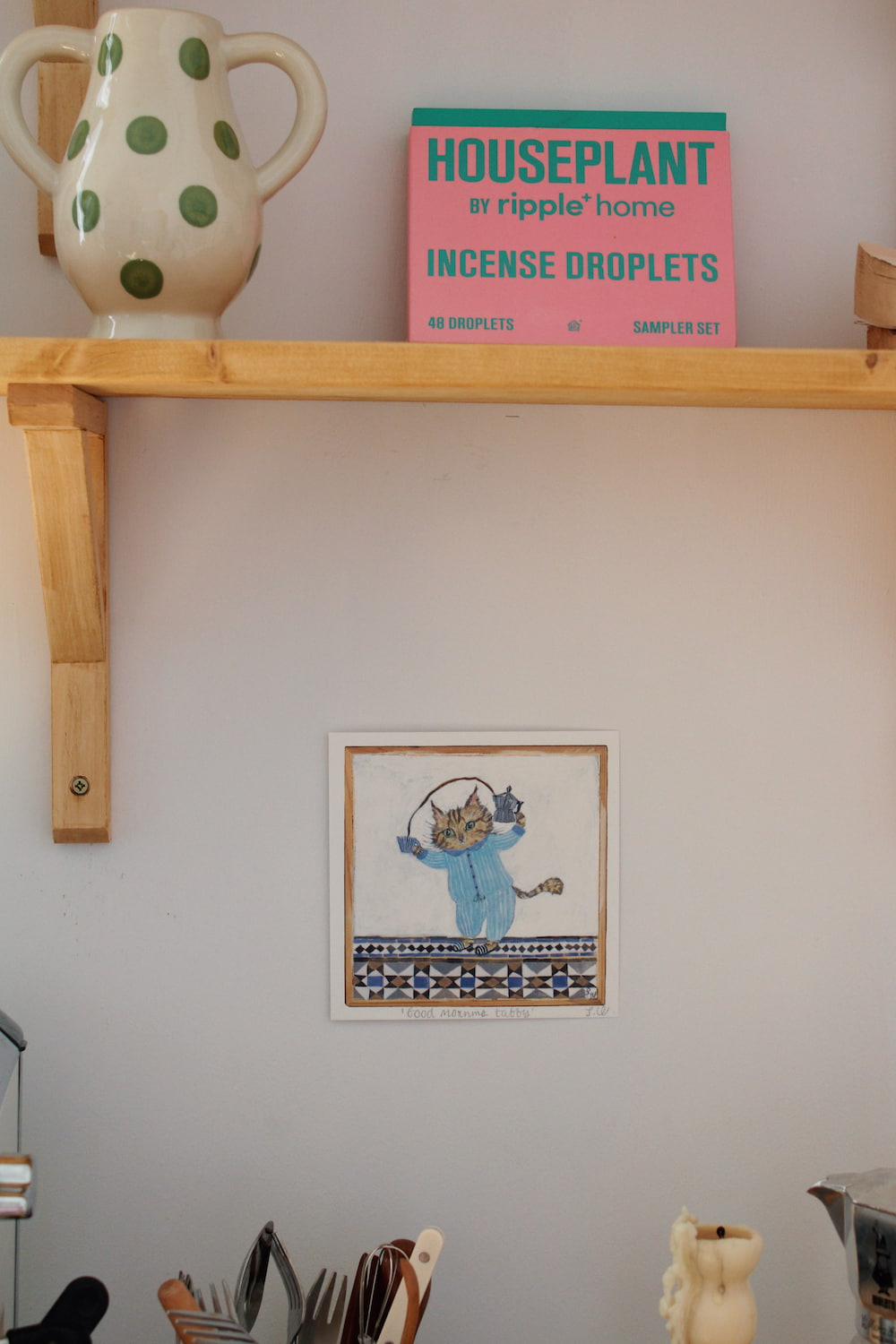 Good Morning Tabby Art Print – illustrated cat art print featuring two cats snuggled together in a blue blanket, styled above a colourful coffee station with ceramic mugs and home accessories