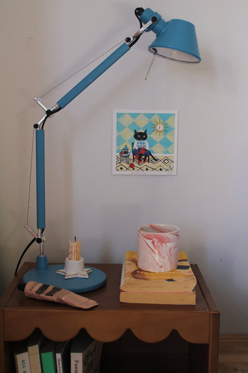 Knitting Cat Art Print – illustrated cat art print styled on a wall above a colourful coffee station with ceramic mugs, books and home decor