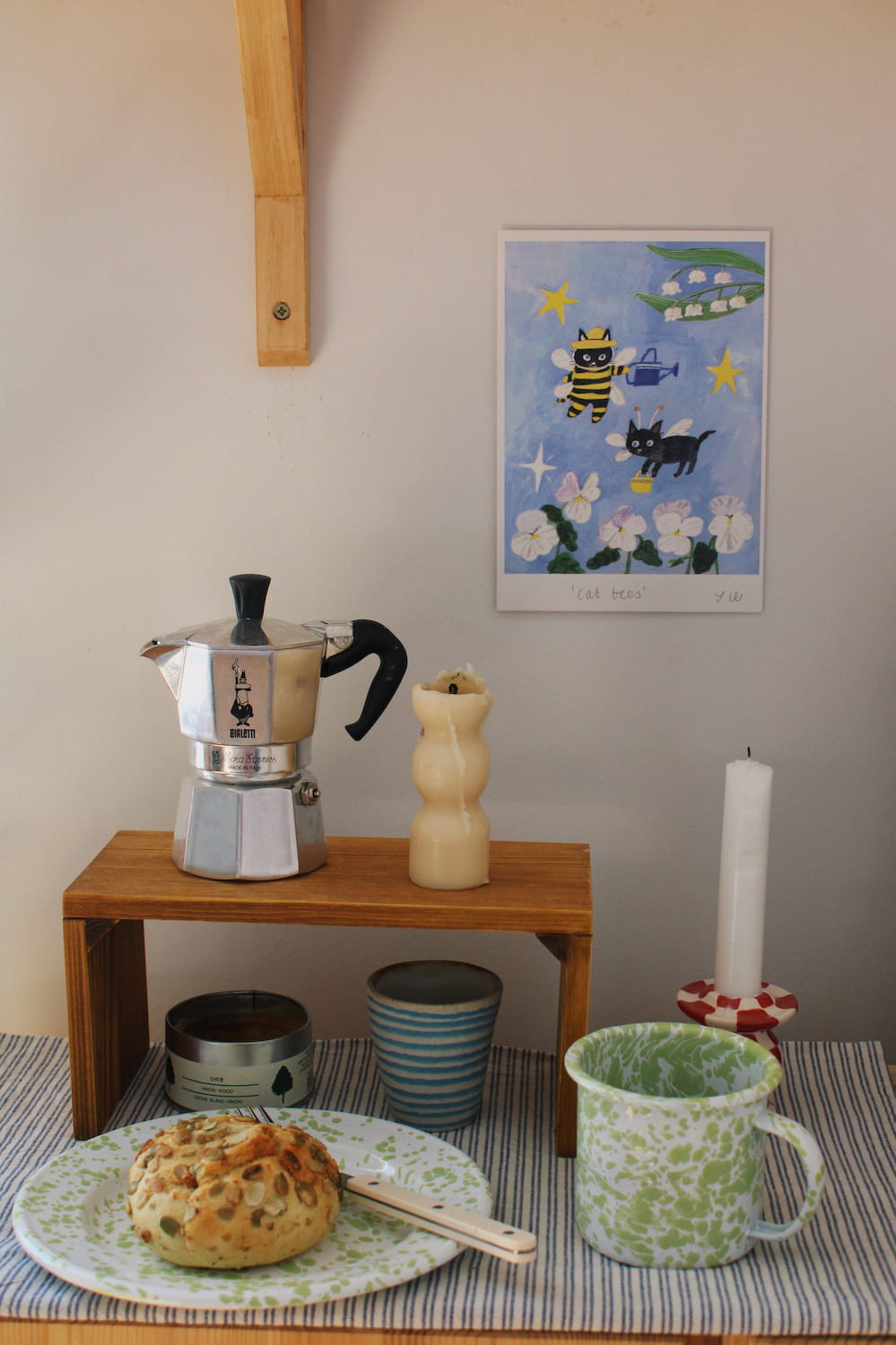 Cat Bees Art Print – illustrated art print featuring two black cats dressed as bees among flowers, styled above a coffee station with colourful ceramics and breakfast tableware