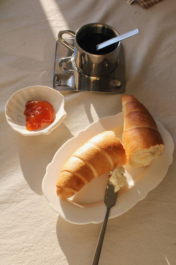 ASunlitCafeMorning tableware bundle with stainless steel cup and white ceramic plate and side dish. 