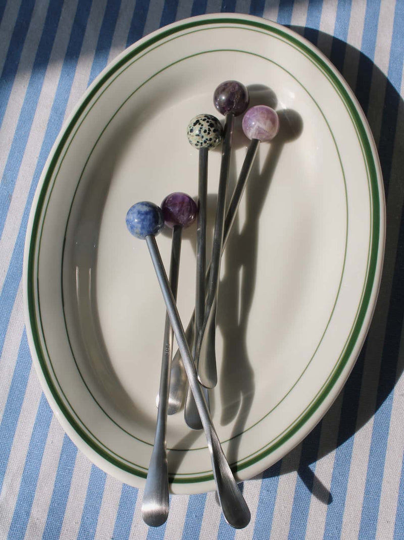 Astra stirrer set displayed on plate with multiple color bead handles.