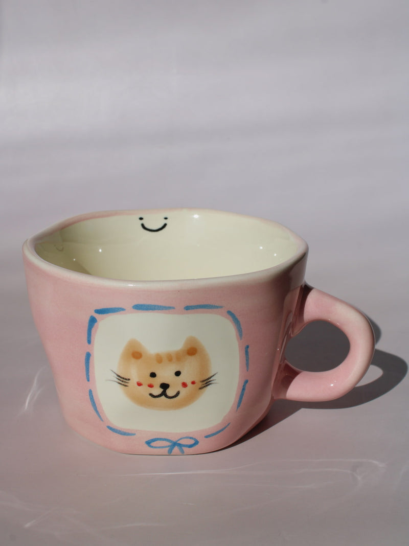 Mimi Ceramic Mug in pink with hand-painted cat face and smiley face inside, handmade ceramic coffee mug