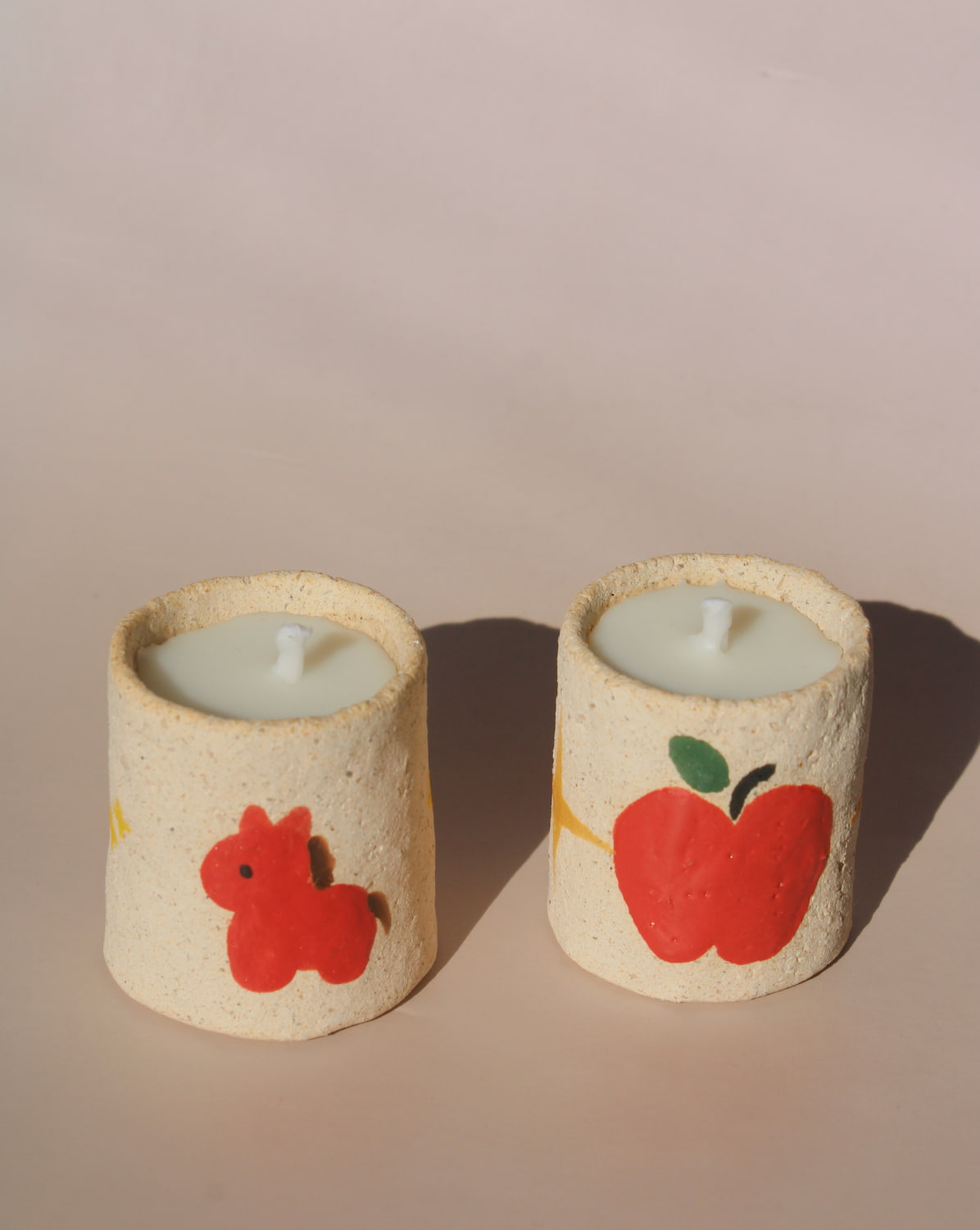 Ponino mini scented candles in handmade ceramic holders with apple and pony motifs, playful decorative candle for cozy home decor.