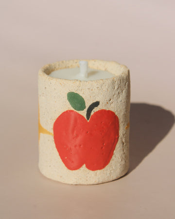 Pomelle mini scented candle in handmade ceramic holder with red apple motif, cute decorative candle for cozy home decor.