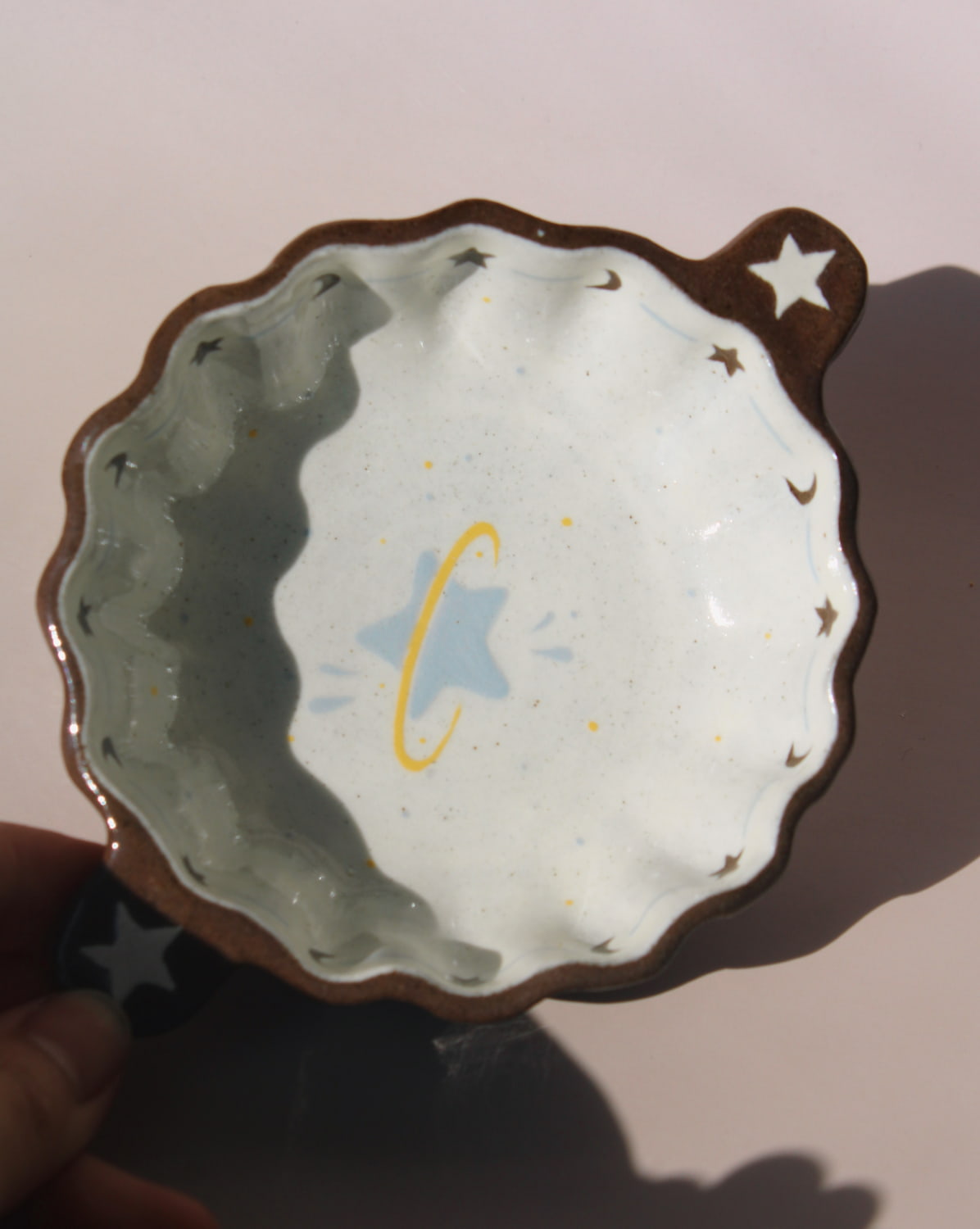 Nebula handmade ceramic sauce dish with scalloped rim and celestial star motif, small dipping bowl for modern table settings.