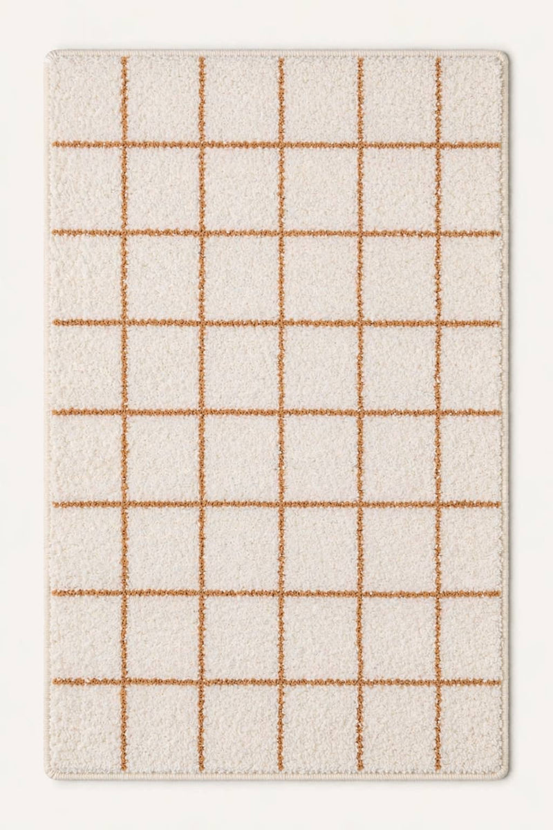Grid-patterned rug with beige lines on a white background