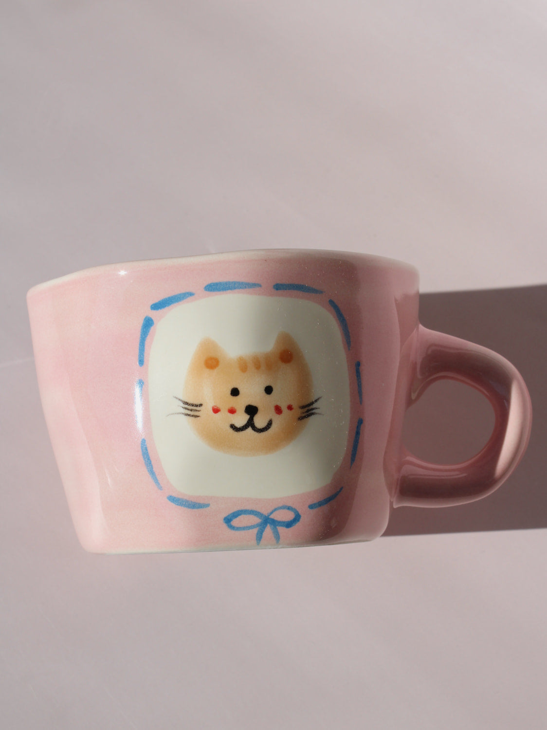 Mimi Ceramic Mug in pink with hand-painted cat face and smiley face inside, handmade ceramic coffee mug