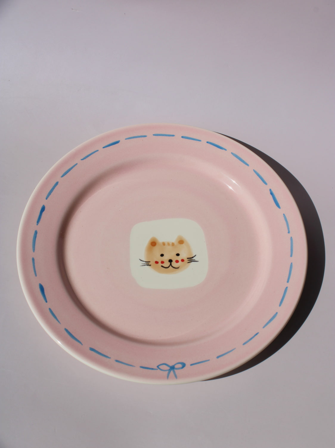 Mimi Ceramic Plate in pink with hand-painted cat face and blue dashed border, handmade ceramic dessert plate