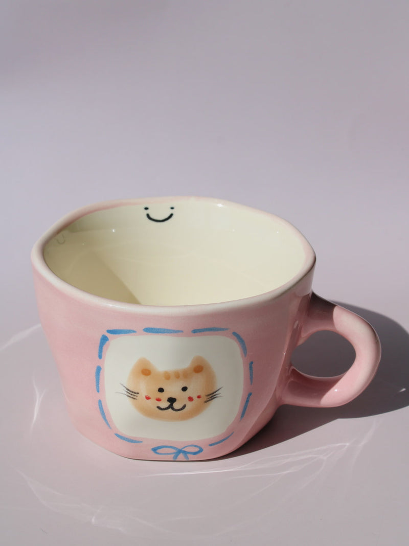 Mimi Ceramic Mug in pink with hand-painted cat face and smiley face inside, handmade ceramic coffee mug