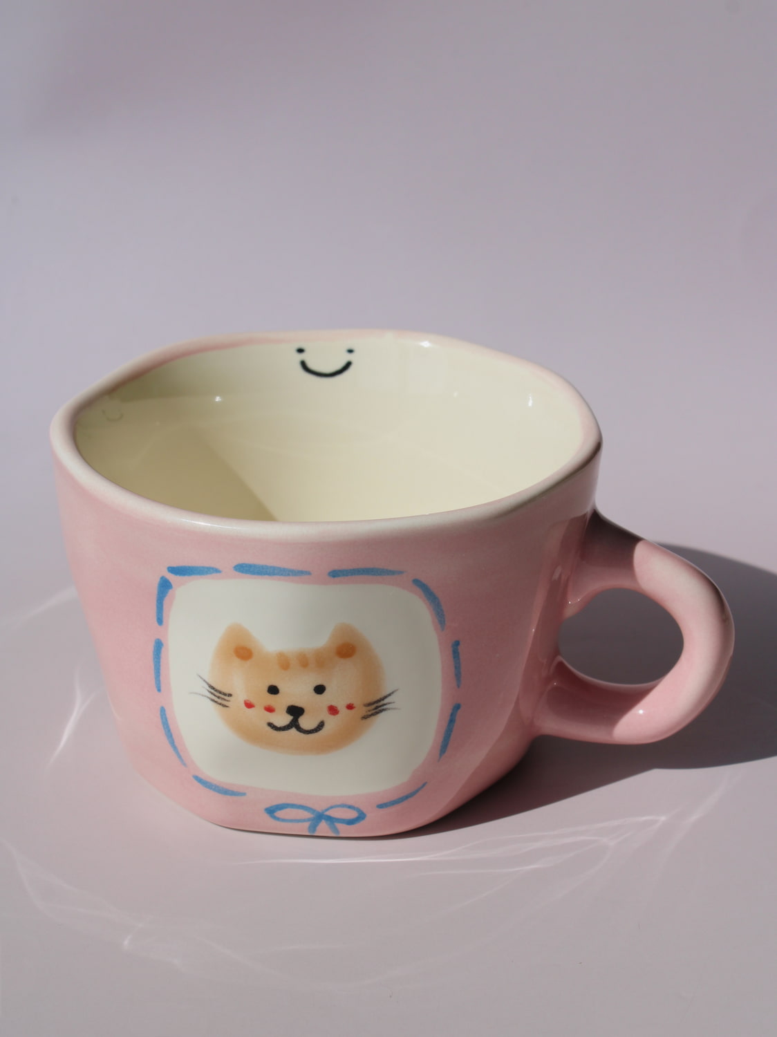 Mimi Ceramic Mug in pink with hand-painted cat face and smiley face inside, handmade ceramic coffee mug