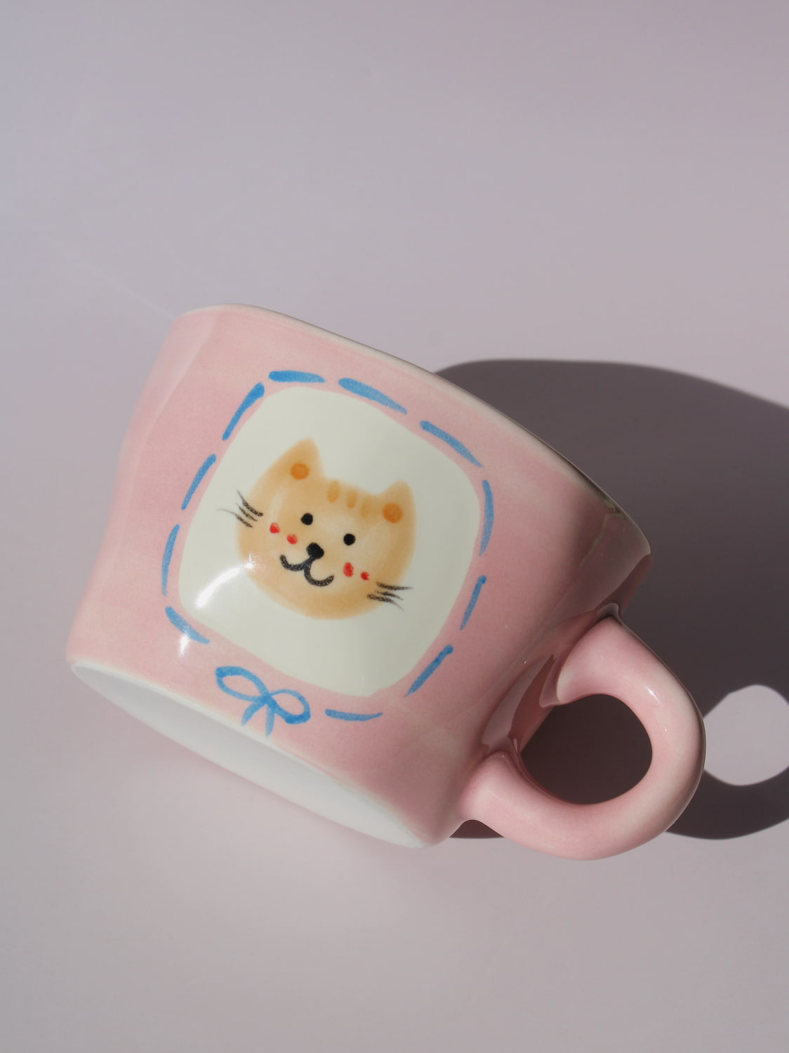 Mimi Ceramic Mug in pink with hand-painted cat face and smiley face inside, handmade ceramic coffee mug