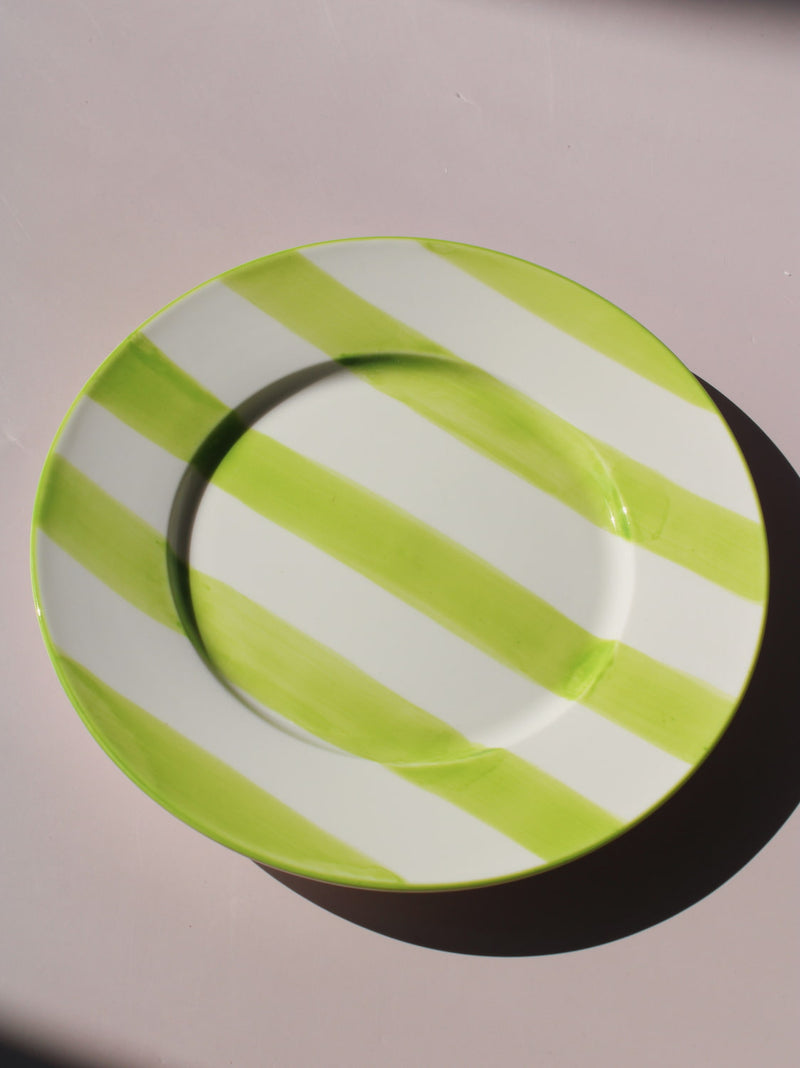 Olia Plate with bold green and white stripes, styled with a wooden fork, handmade ceramic plate top view