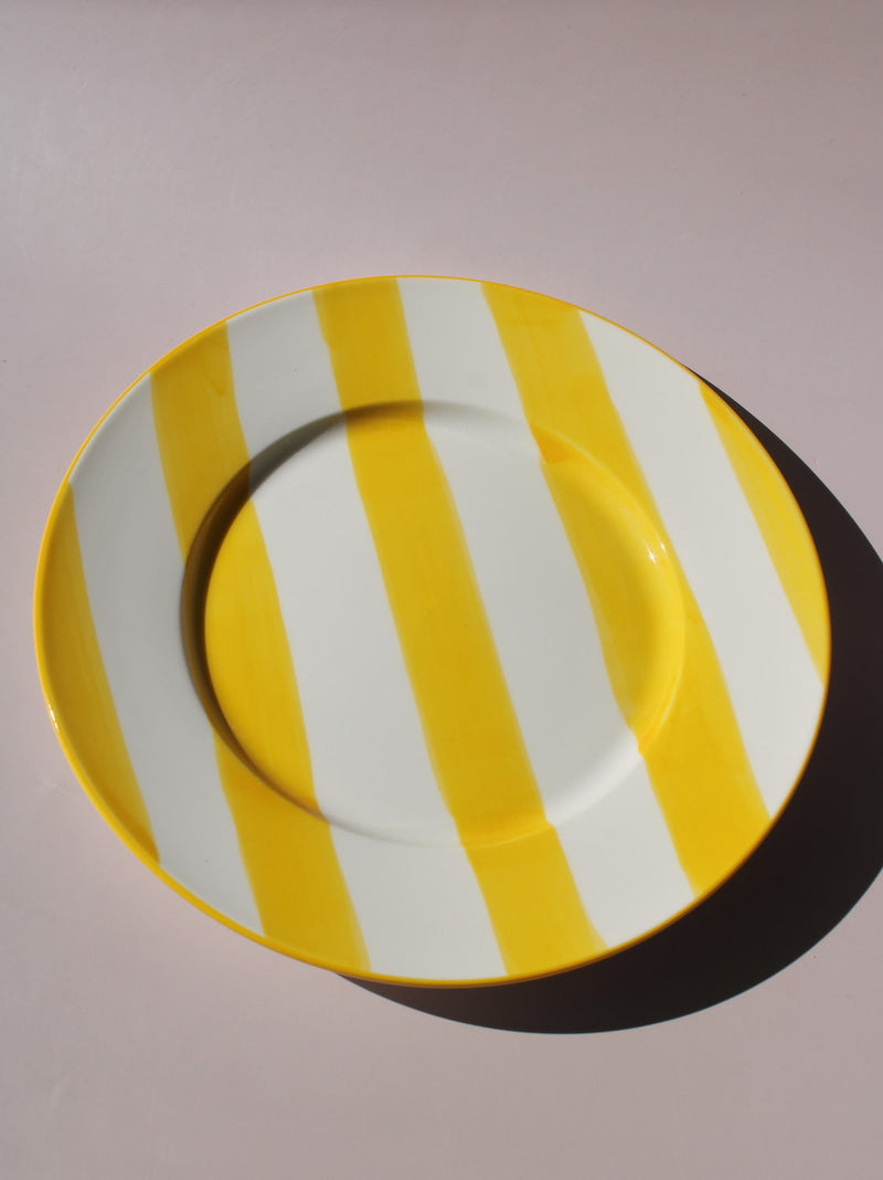 Etta Plate with bold yellow and white stripes, styled with a wooden fork, handmade ceramic plate top view