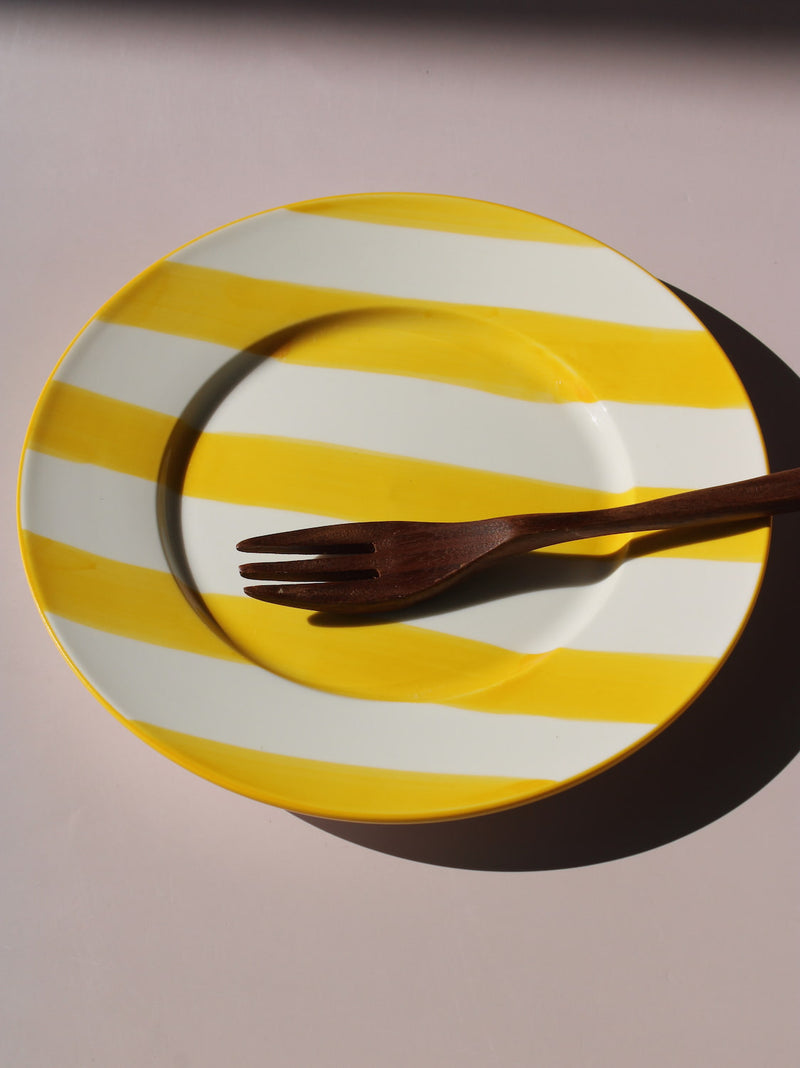 Etta Plate with bold yellow and white stripes, styled with a wooden fork, handmade ceramic plate top view