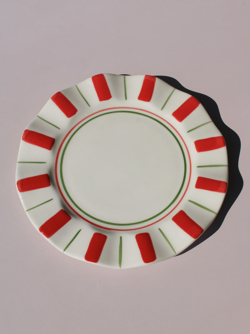 Riviera Ceramic Plate with red and green sunray pattern on scalloped rim, handmade ceramic dessert plate top view