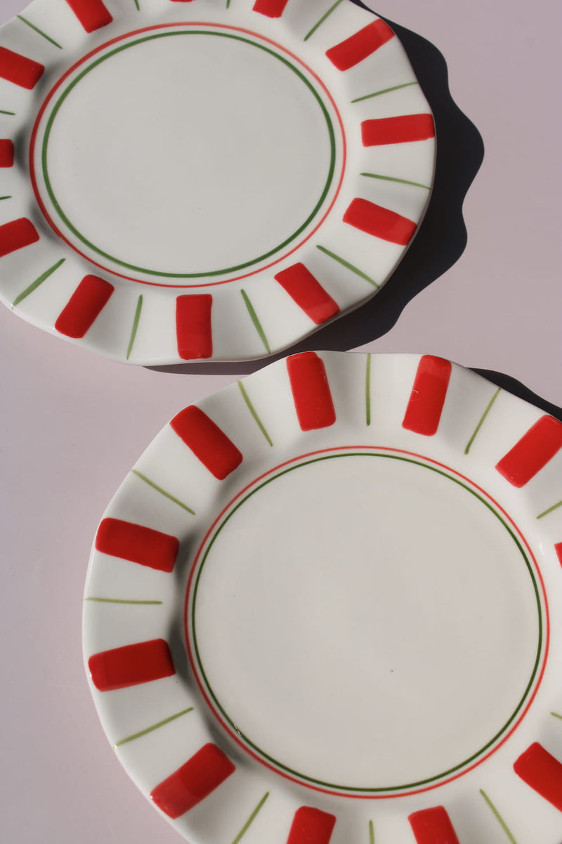 Riviera Ceramic Plate with red and green sunray pattern on scalloped rim, handmade ceramic dessert plate top view