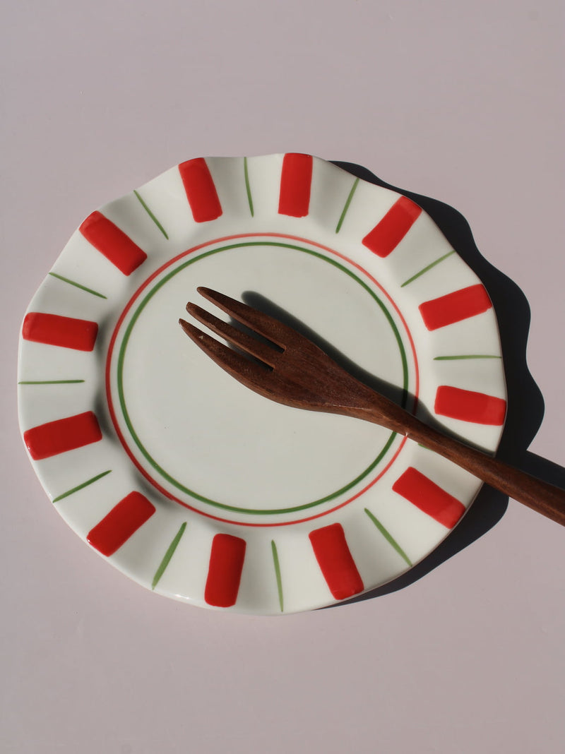 Riviera Ceramic Plate with red and green sunray pattern on scalloped rim, handmade ceramic dessert plate top view