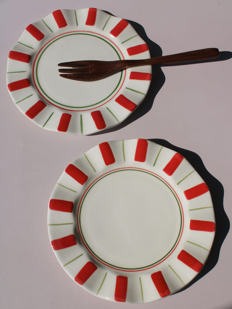 Riviera Ceramic Plate with red and green sunray pattern on scalloped rim, handmade ceramic dessert plate top view