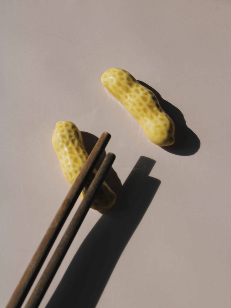 Peanut Ceramic Chopstick Rest Set shaped like peanut shells, styled with wooden chopsticks, handmade ceramic