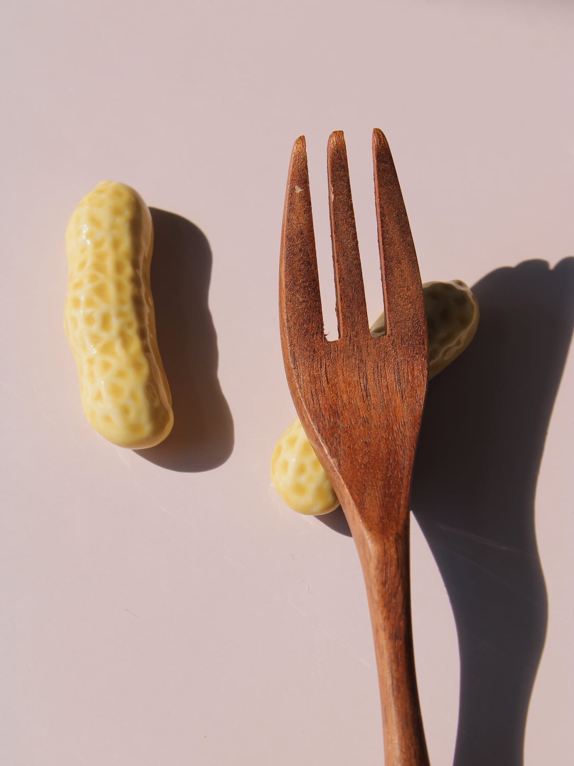 Peanut Ceramic Chopstick Rest Set shaped like peanut shells, styled with wooden chopsticks, handmade ceramic