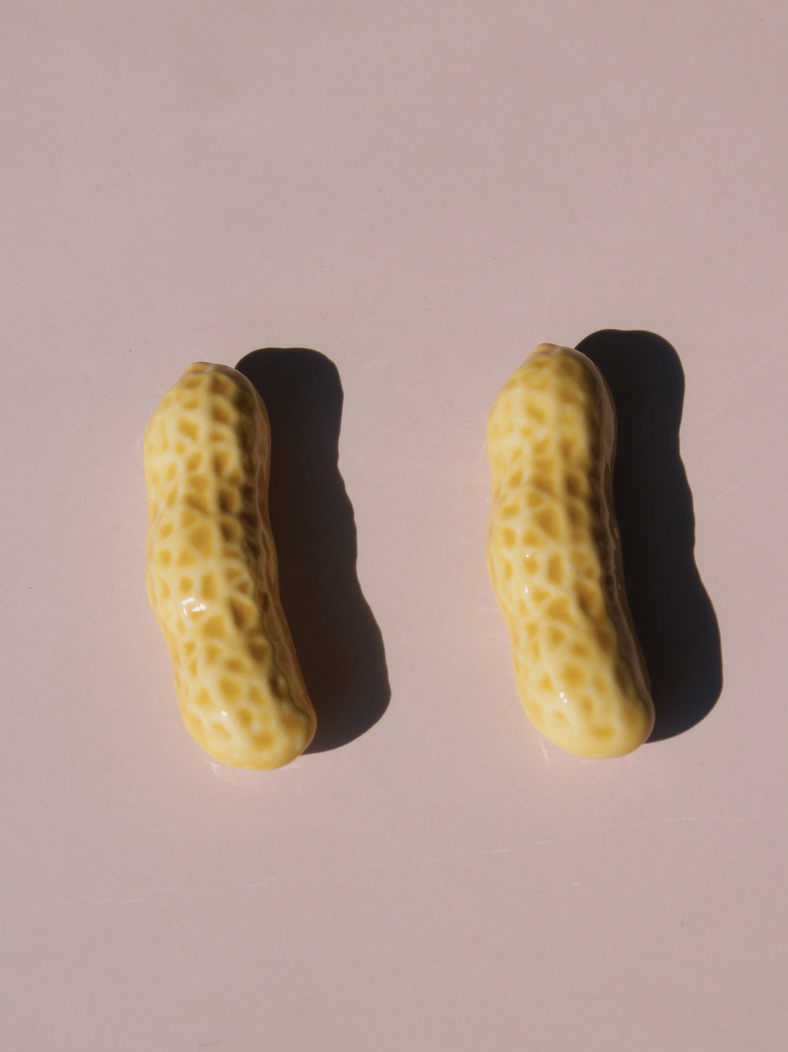 Peanut Ceramic Chopstick Rest Set shaped like peanut shells, styled with wooden chopsticks, handmade ceramic