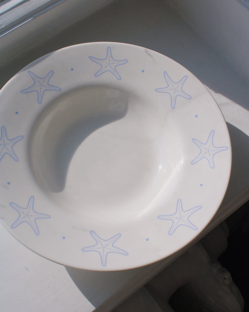 Astrella ceramic plate with blue starfish motif, coastal inspired tableware for seafood, pasta, or everyday dining.