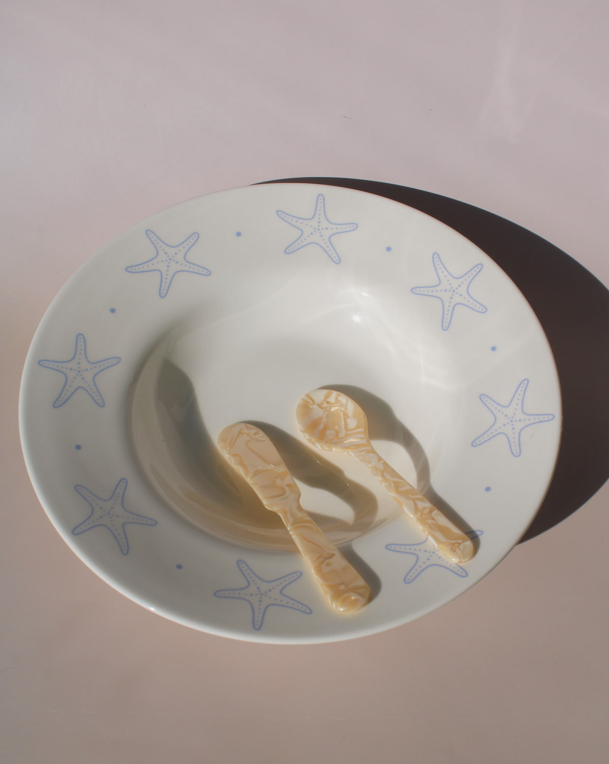 Astrella ceramic plate with blue starfish motif, coastal inspired tableware for seafood, pasta, or everyday dining.