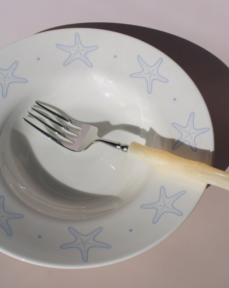 Astrella ceramic plate with blue starfish motif, coastal inspired tableware for seafood, pasta, or everyday dining.