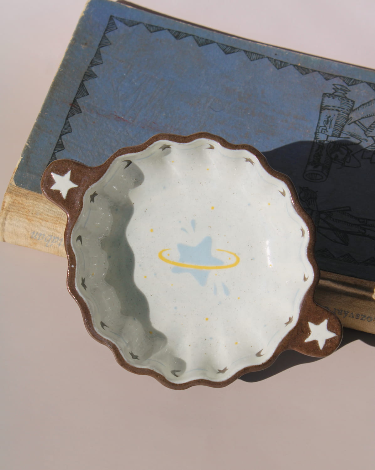 Nebula handmade ceramic sauce dish with scalloped rim and celestial star motif, small dipping bowl for modern table settings.