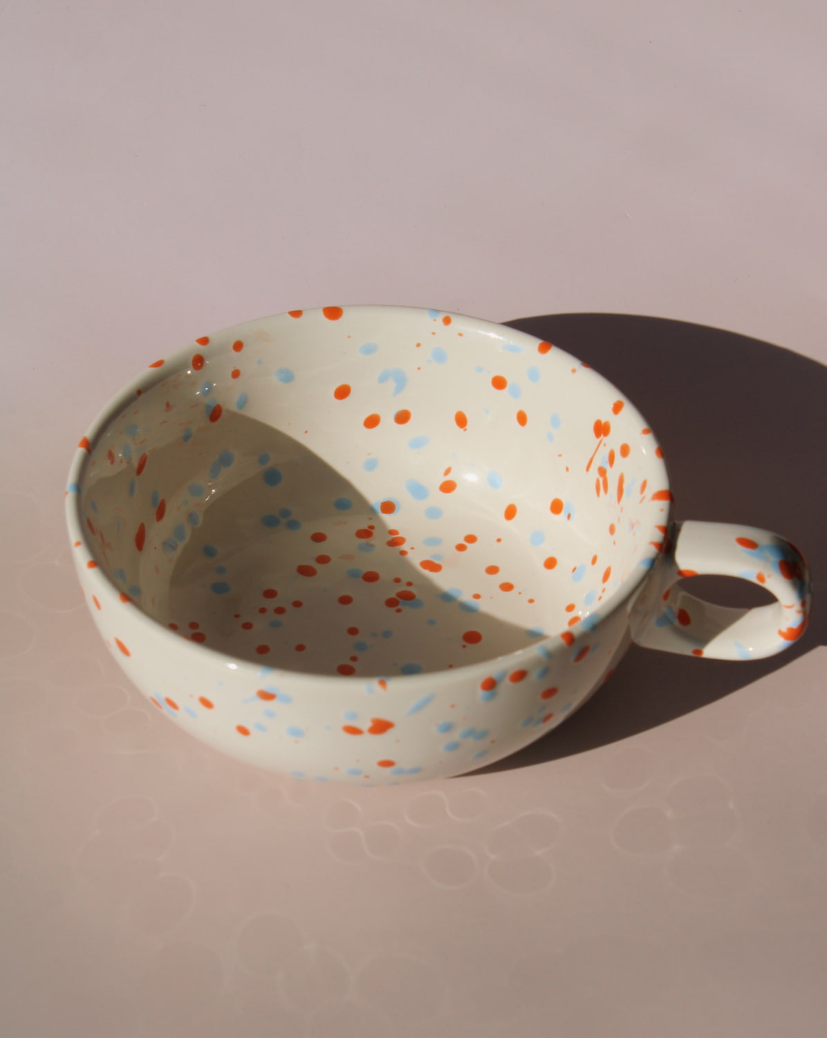 Naro ceramic bowl with blue and orange speckled glaze, handmade soup bowl with handle for everyday dining.
