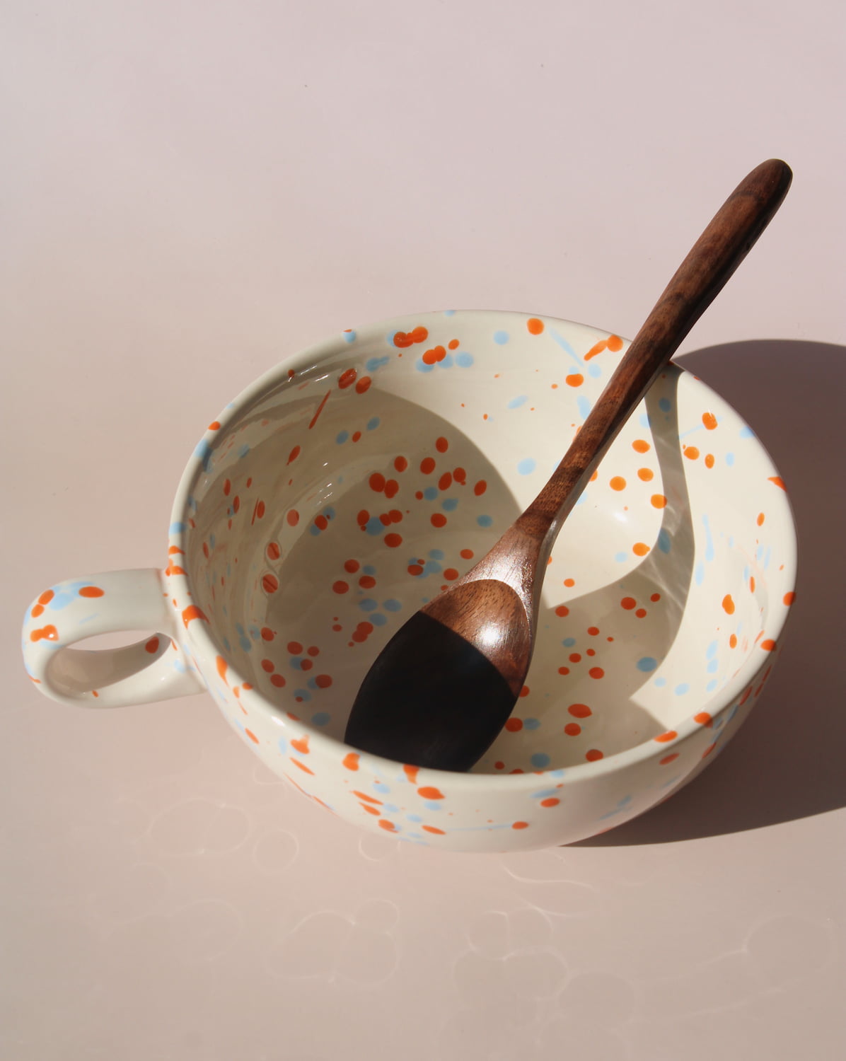 Naro ceramic bowl with blue and orange speckled glaze, handmade soup bowl with handle for everyday dining.