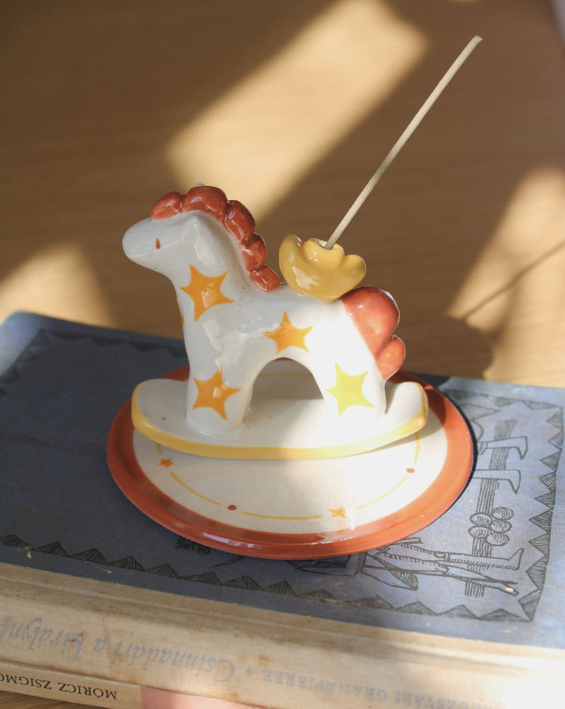 Ponyo ceramic horse incense holder with yellow stars and warm terracotta accents, whimsical ceramic incense burner with star tray.