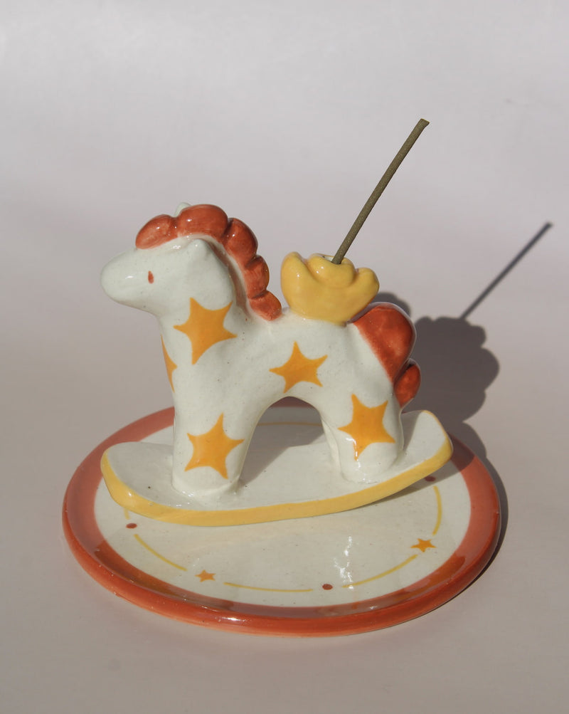 Ponyo ceramic horse incense holder with yellow stars and warm terracotta accents, whimsical ceramic incense burner with star tray.