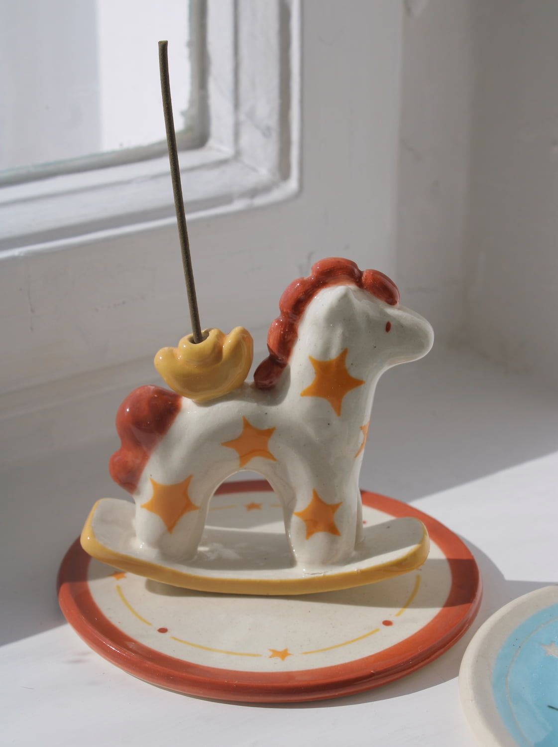 Ponyo ceramic horse incense holder with yellow stars and warm terracotta accents, whimsical ceramic incense burner with star tray.