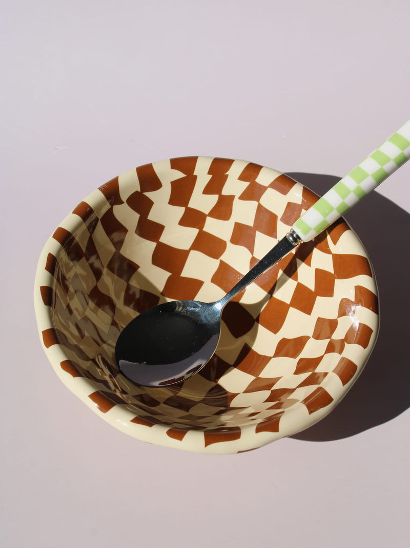 Nova Ceramic Bowl with brown and cream checkered pattern, styled with a green checkered spoon, handmade ceramic bowl top view